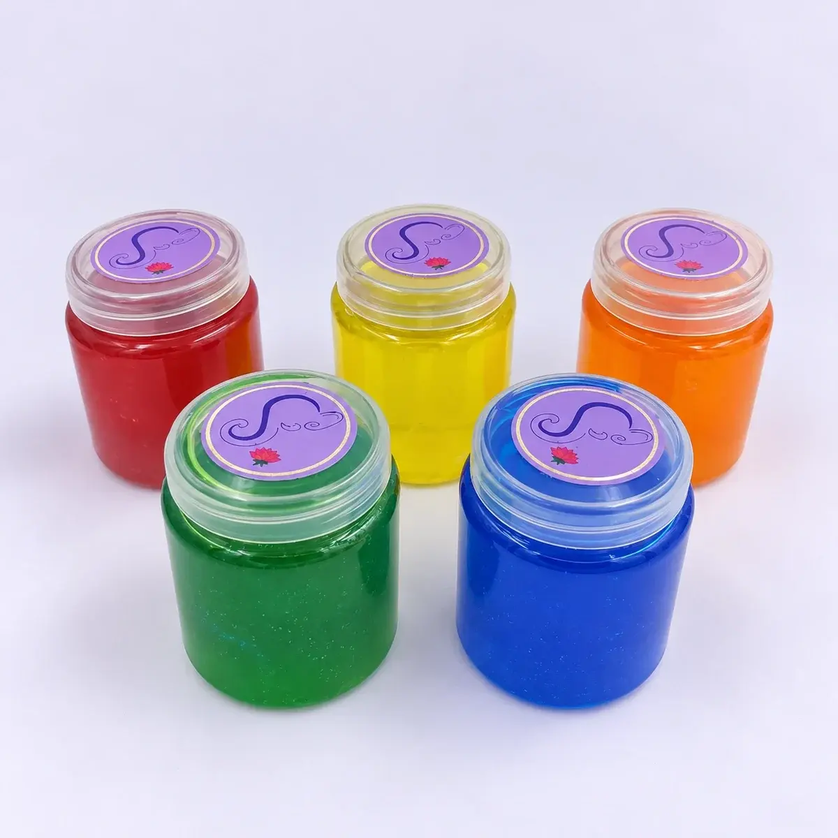 Liquid Luck glitter slime jars in red, yellow, orange, green and blue